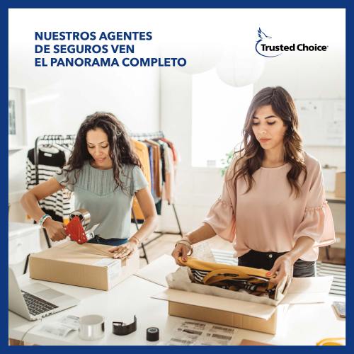 Two business women packing boxes