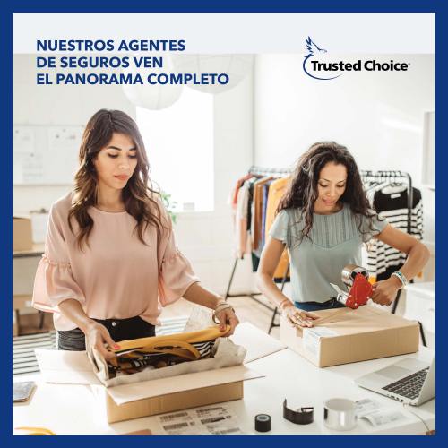 Two business women packing boxes